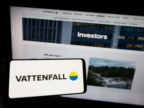 Stuttgart, Germany - 08-14-2023: Person holding smartphone with logo of Swedish energy company Vattenfall AB on screen in front of website. Focus on phone display.