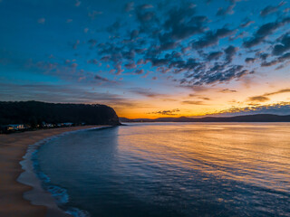 Aerial sunrise seascape with pretty cloud filled sky