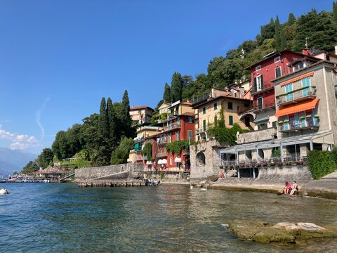 Colourful amazing facades of Italy buildings in the lake, river, sea and in the city center. Sunny day in Italy. Sightseeing in Milano, Genoa, Varenna, Bergamo, Lake Como.