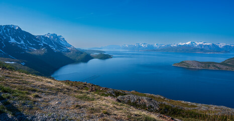 Fototapeta premium Wonderful view of sea coast of fjord surrounded by high mountains.