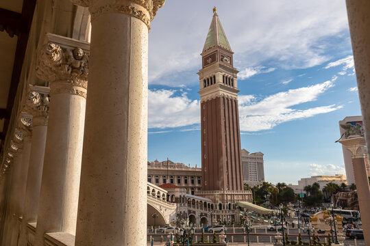 Scenic view of replica bell tower of luxury hotel Venetian seen through majestic white stone pillars on the  Las Vegas Strip, Nevada, USA. Gambling, party, freedom and no limits concept