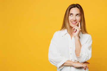 Young caucasian minded happy woman she wear white shirt casual clothes put hand prop up on chin,...
