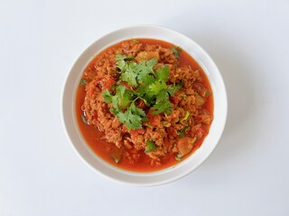 Nam Prik Ong, northern Thai food sauteed with ground pork, tomatoes and chili isolated on white background.
