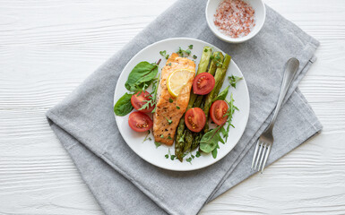 Baked Delicious salmon, green asparagus on  plate