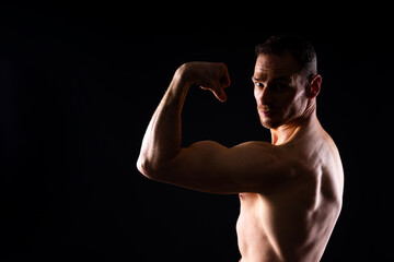 Man athlete isolated on black, red, white background. Fitness motivation.