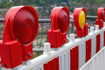 Construction safety. Street barricade with warning signal lamps on a road