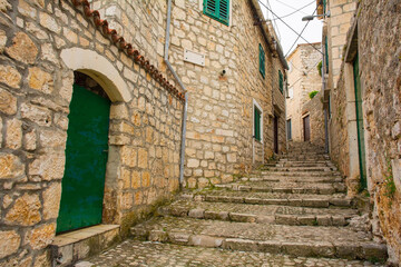 Naklejka premium A residential street in the historic coastal village of Sutivan, Brac Island, Croatia