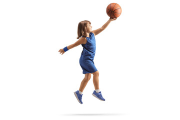 Little girl in a blue sports jersey shooting a layup