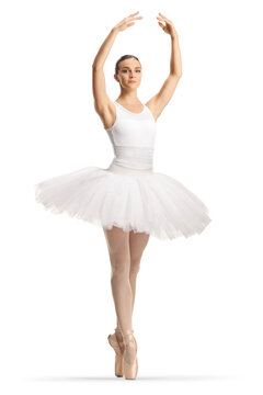 Ballerina in a white tutu dress dancing with arms up