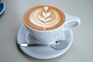 Close up cup of hot Latte art coffee on wooden table