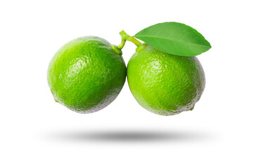 Flying green lime with leaves isolated on white background. clipping path.