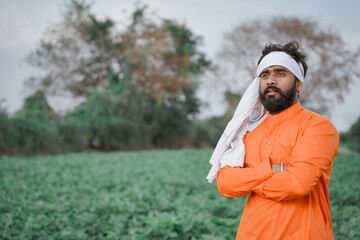 Young Indian farmer standing at Agriculture field