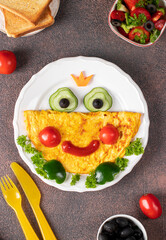 Breakfast idea for kids - frog princees shaped of omelette with vegetables, View from above