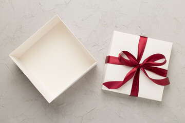Open gift box on concrete background, top view. Mock up for design