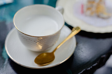 White milk glass with beautiful coasters in a coffee shop.