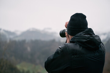 Traveler photographer and beautiful mountains. Travel hiking and freedom while freelancing concept. Beautiful Alps.