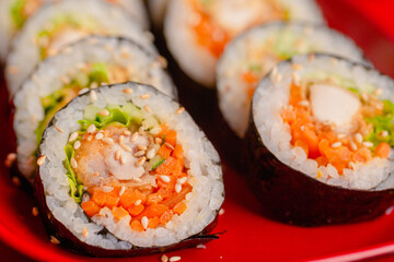 Fried chicken kimbap with Korean seaweed rice on a red plate