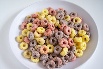 Cereal for breakfast is served on a white plate with a white background