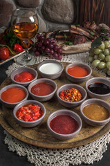 Set of different sauces on rustic georgian background