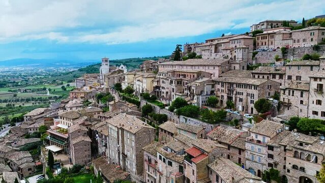 Saint Francis Town Of Assisi Along The Slopes Of Monte Subasio In Perugia Province, Umbria Region, Central Italy. Aerial Drone Shot