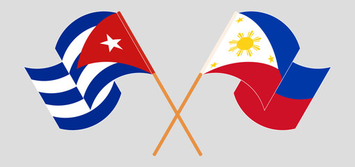 Crossed and waving flags of Cuba and the Philippines