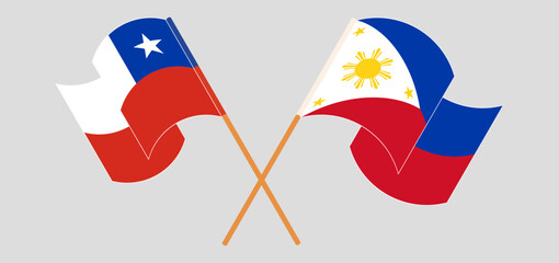 Crossed and waving flags of Chile and the Philippines