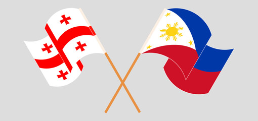 Crossed and waving flags of Georgia and the Philippines