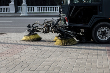 Sweeping machine brushes clean the city sidewalk