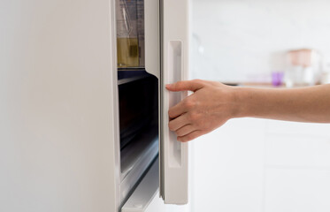 opening white refrigerator door