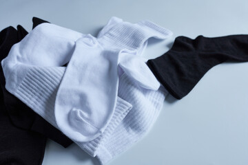White and black socks on a white background. Close-up.