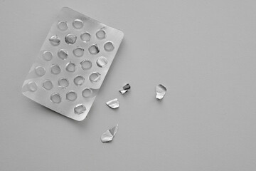 Pills blister pack on a white background. Top view food supplements empty packaging. Medicine...