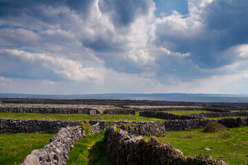 Huge maze of traditional stone fences and fields in the background. Aran Island, county Galway, Ireland. Popular travel destination with stunning nature scenery.