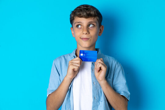 Photo of cheerful MODEL hold debit card look empty space