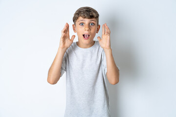 Surprised happy Beautiful kid boy wearing grey casual t-shirt , glad to see big discounts on...