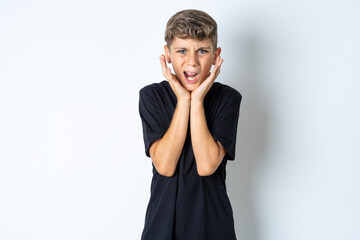 Upset Beautiful kid boy wearing black casual t-shirt touching face with two hands