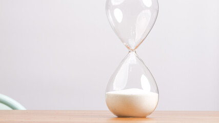 Hourglass lying on white background tabletop