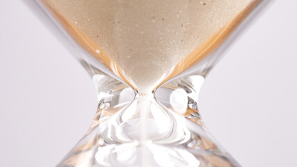Hourglass lying on white background tabletop