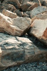 Fototapeta premium The stones are large, rock fragments, the street is sunny.