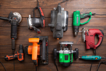 Set of electric tools on the wooden table. Various power tools for renovation and construction - 638806334