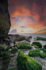 lanscape views of indrayanti beach yogyakarta gunungkidul indonesia  cliffs and rocks on the seafront with beautiful clouds at sunrise or sunset