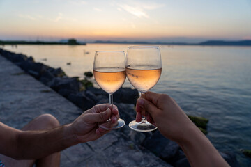 drinking wine on a date next to lake Balaton at sunset in Balatonlelle