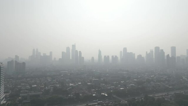 Air pollution in jakarta shot from a drone flying in the morning