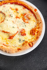 pizza four cheeses mozzarella, gorgonzola, parmesan, emmental cheese portioned slice ready to eat appetizer meal food snack on the table copy space food background rustic top view
