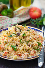 Traditional Mediterranean Levantine salad Tabbouleh with couscous and fresh summer vegetables