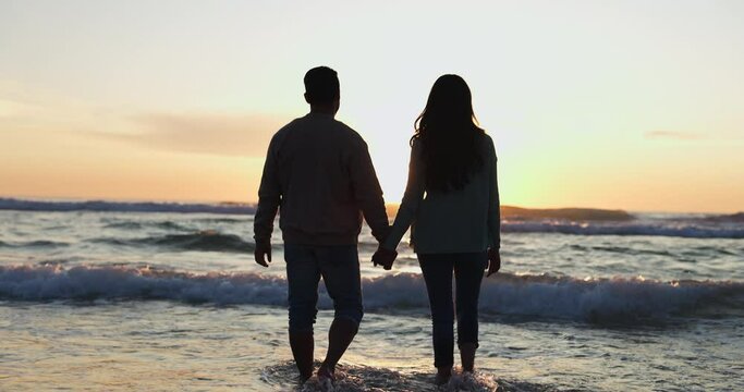 Holding hands, sunset and silhouette of couple at beach for relax, summer vacation and travel. Happy, adventure and wellness with man and woman on seaside date for holiday, marriage or peace together