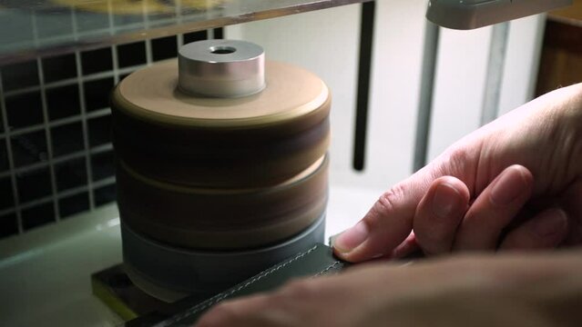 Closeup view 4k stock video footage of hands of worker sewing bag. Person works with leather. Small business concept