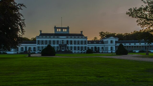 Time lapse of the sun setting behind a beautiful wide palace in the Netherlands