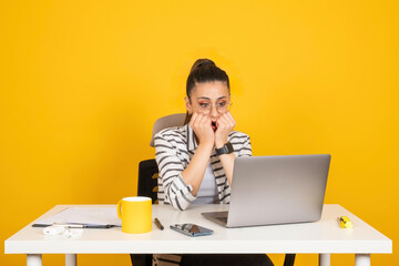Worried business woman employee, portrait of young caucasian brunette worried business woman employee. Sit work office desk using laptop pc computer. Business career concept. Gnawing nails. - obrazy, fototapety, plakaty
