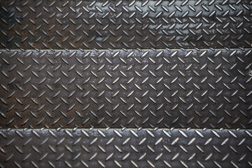 Old rusty black diamond metal plate background, grunge texture of dark metallic sheet with...