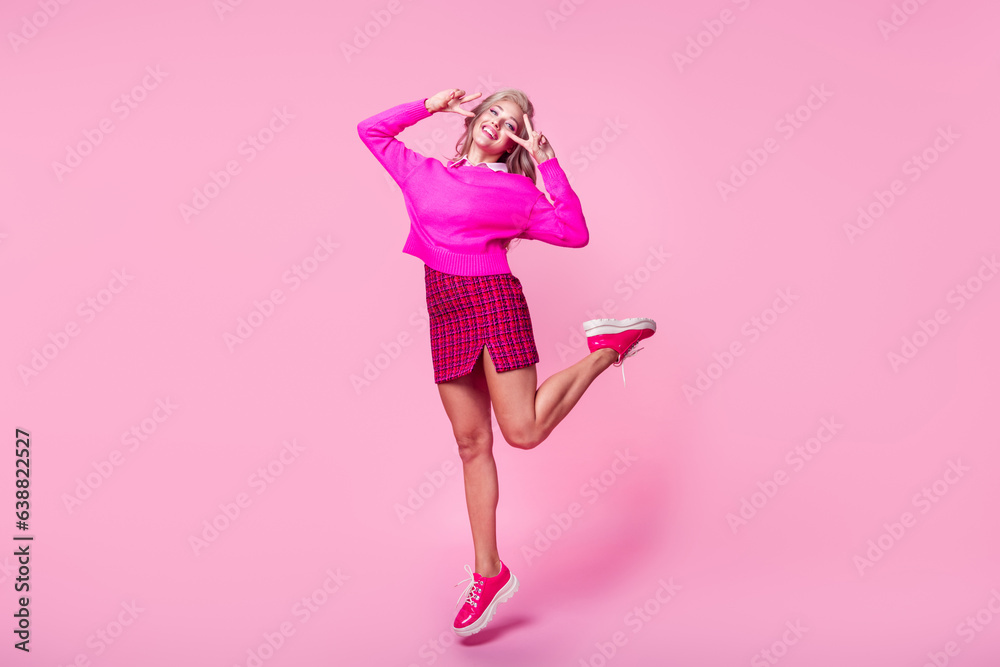 Poster full length photo of cute adorable lady wear sweater jumping high showing v-signs cover eyes isolate